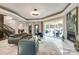 Open living space with fireplace, marble floors, and access to backyard at 4129 Carnoustie Ln, Charlotte, NC 28210