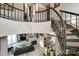 Elegant curved staircase with modern metal railing overlooks the main living area at 4129 Carnoustie Ln, Charlotte, NC 28210