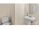 Powder room with white pedestal sink and toilet at 4866 Breden St, Kannapolis, NC 28081