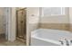 Bathroom featuring large tub and glass door shower at 4866 Breden St, Kannapolis, NC 28081