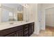Bright bathroom featuring a double sink vanity with dark wood cabinets and a large mirror at 4866 Breden St, Kannapolis, NC 28081