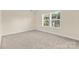 Bedroom features neutral carpet, light walls, and a window providing natural light at 4866 Breden St, Kannapolis, NC 28081