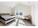 Airy bedroom with a large window, cozy chair, and comfortable bed, creating a relaxing atmosphere at 4866 Breden St, Kannapolis, NC 28081