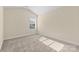 Bedroom features neutral carpet, light walls, sloped ceiling, and a window for natural light at 4866 Breden St, Kannapolis, NC 28081