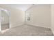 Bedroom with neutral carpet, light walls, dormer window, and doorway to another room at 4866 Breden St, Kannapolis, NC 28081