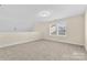 Bright and airy bonus room with neutral carpet and a large window with blinds at 4866 Breden St, Kannapolis, NC 28081