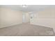 Spacious bonus room with neutral carpet, white walls, and several doorways at 4866 Breden St, Kannapolis, NC 28081