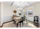 Bright dining room featuring a stylish chandelier, hardwood floors, and large windows at 4866 Breden St, Kannapolis, NC 28081