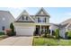 Charming two-story home featuring a covered front porch, neutral siding, and attached two-car garage at 4866 Breden St, Kannapolis, NC 28081