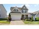 Charming two-story home with a two-car garage, manicured landscaping, and welcoming front porch at 4866 Breden St, Kannapolis, NC 28081