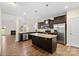 Spacious kitchen with a large island, dark wood cabinetry, and stainless steel appliances at 4866 Breden St, Kannapolis, NC 28081