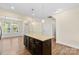 Granite-topped kitchen island with dark cabinetry and open-concept living at 4866 Breden St, Kannapolis, NC 28081