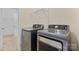 Laundry room with gray Samsung washer and dryer, and overhead wire shelving at 4866 Breden St, Kannapolis, NC 28081