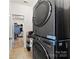 Convenient laundry room with modern, stacked washer and dryer and storage shelves at 4866 Breden St, Kannapolis, NC 28081