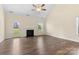 Bright living room featuring a fireplace, hardwood floors, and access to the backyard at 4866 Breden St, Kannapolis, NC 28081