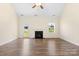 Bright living room featuring a fireplace, hardwood floors and door to backyard at 4866 Breden St, Kannapolis, NC 28081