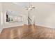 Open-concept living room with hardwood floors, ceiling fan, and view into kitchen bar at 4866 Breden St, Kannapolis, NC 28081