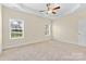 Large carpeted main bedroom with two windows and ceiling fan at 4866 Breden St, Kannapolis, NC 28081