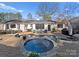 Luxurious backyard pool with spa, lounge area, and manicured landscaping at 5630 Timber Ln, Charlotte, NC 28270