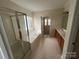A spacious bathroom with a glass-enclosed shower and a soaking tub at 5934 Hickory Hollow Ct, Harrisburg, NC 28075