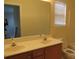 Bathroom with double sink vanity, large mirror, toilet, tub, and natural light from window at 5934 Hickory Hollow Ct, Harrisburg, NC 28075