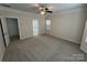 Spacious bedroom with neutral walls, a ceiling fan, and an ensuite bathroom at 5934 Hickory Hollow Ct, Harrisburg, NC 28075
