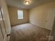 Bedroom featuring a window and neutral walls with carpeted floors at 5934 Hickory Hollow Ct, Harrisburg, NC 28075
