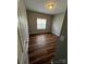 Bedroom featuring neutral walls, wood-look flooring, and a window at 5934 Hickory Hollow Ct, Harrisburg, NC 28075
