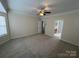 Bedroom with neutral carpet, ceiling fan, and multiple doorways at 5934 Hickory Hollow Ct, Harrisburg, NC 28075