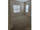 Bedroom with neutral walls, carpeted floors, and large windows at 5934 Hickory Hollow Ct, Harrisburg, NC 28075
