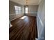 Sunlit dining area with wood-look floors, and a classic chandelier at 5934 Hickory Hollow Ct, Harrisburg, NC 28075