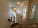 Second floor hallway featuring carpet and access to multiple rooms at 5934 Hickory Hollow Ct, Harrisburg, NC 28075