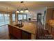 Open kitchen with granite island, stainless steel appliances, and wood floors at 5934 Hickory Hollow Ct, Harrisburg, NC 28075
