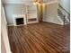 Spacious living room with fireplace, built-in shelving, and wood floors at 5934 Hickory Hollow Ct, Harrisburg, NC 28075