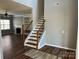 Staircase with wooden railings and white risers, leading to the upper level at 5934 Hickory Hollow Ct, Harrisburg, NC 28075