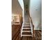 Elegant staircase with wood treads, white risers, and ornate black iron spindles at 5934 Hickory Hollow Ct, Harrisburg, NC 28075