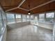 Inviting sunroom featuring tile floors, wood ceiling, large windows, and an access door to the backyard at 5934 Hickory Hollow Ct, Harrisburg, NC 28075
