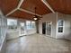 Spacious sunroom with tile flooring, wood ceiling, exterior access, and sliding door into the home at 5934 Hickory Hollow Ct, Harrisburg, NC 28075