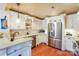 Charming kitchen with white cabinets, stainless steel appliances, and wood flooring at 615 Portside Dr, Davidson, NC 28036