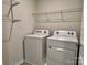 Convenient laundry area with washer, dryer, and overhead shelving at 751 Little Bluestem Dr, Clover, SC 29710