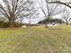 Expansive backyard with mature trees and storage shed at 7514 Highway 205 Hwy, Marshville, NC 28103