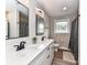 Bright bathroom featuring a double vanity, and a black shower curtain with a tile floor at 7514 Highway 205 Hwy, Marshville, NC 28103