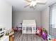 This playroom features a ceiling fan, a window, and beautiful wood floors at 7514 Highway 205 Hwy, Marshville, NC 28103