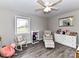 This charming bedroom features a ceiling fan, a window, and beautiful wood floors at 7514 Highway 205 Hwy, Marshville, NC 28103