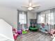 This playroom features a ceiling fan, a window, and beautiful wood floors at 7514 Highway 205 Hwy, Marshville, NC 28103
