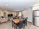 Dining area seamlessly connects to the living room and kitchen with stainless steel refrigerator at 7514 Highway 205 Hwy, Marshville, NC 28103