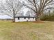 Rear view of white painted home with mature trees and lawn at 7514 Highway 205 Hwy, Marshville, NC 28103