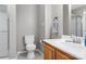 Neutral bathroom featuring a wood vanity, toilet, sink and shower with modern fixtures at 753 Southwest Dr, Davidson, NC 28036