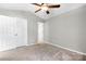 A bright bedroom with neutral walls, a ceiling fan, and carpeted floors is ready for your personal touch at 753 Southwest Dr, Davidson, NC 28036