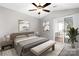 Relaxing bedroom featuring neutral tones, a ceiling fan, and a sliding glass door leading to outdoor patio at 753 Southwest Dr, Davidson, NC 28036